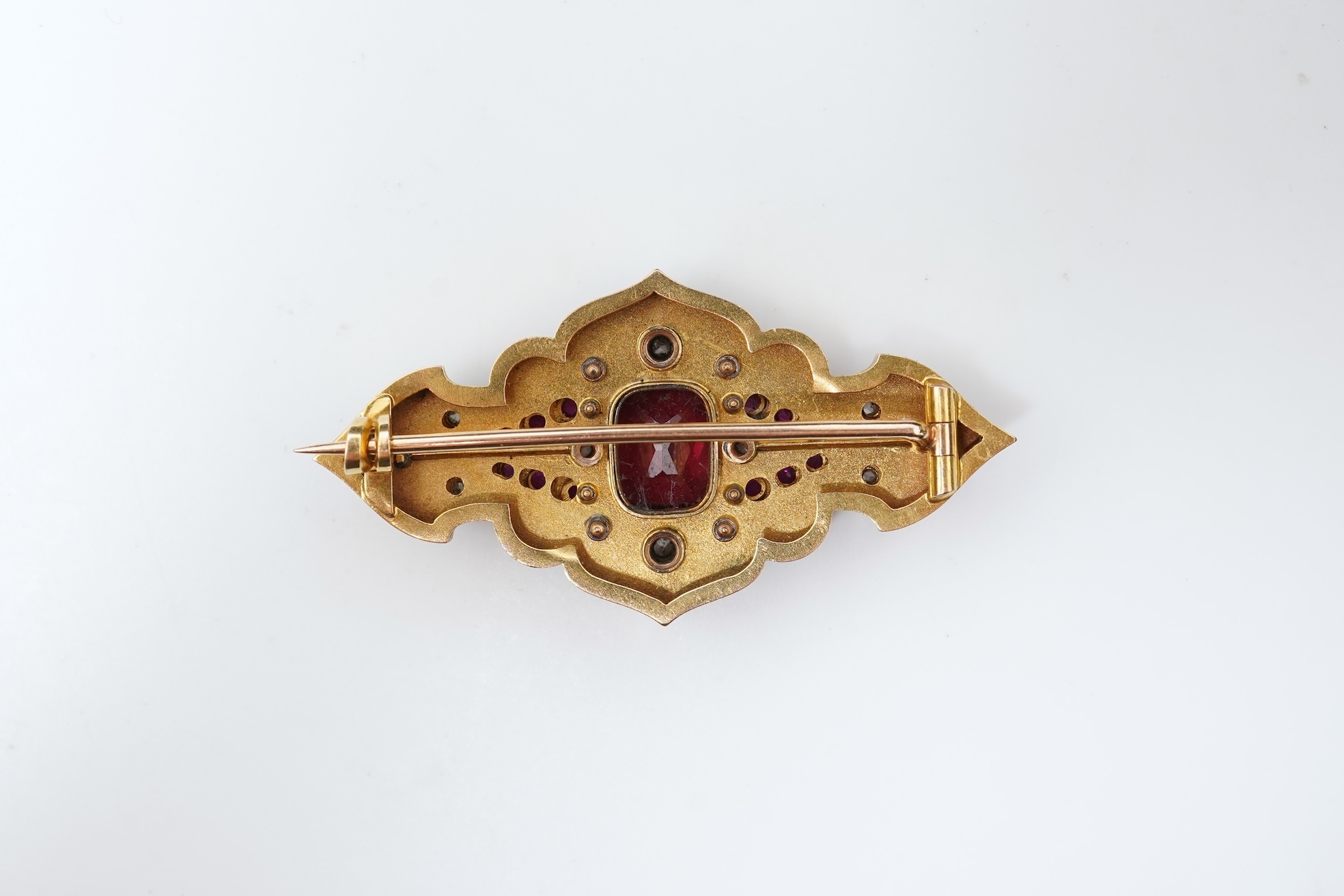 A fine Victorian Renaissance Revival tourmaline, diamond, ruby and enamel brooch, late 19th century